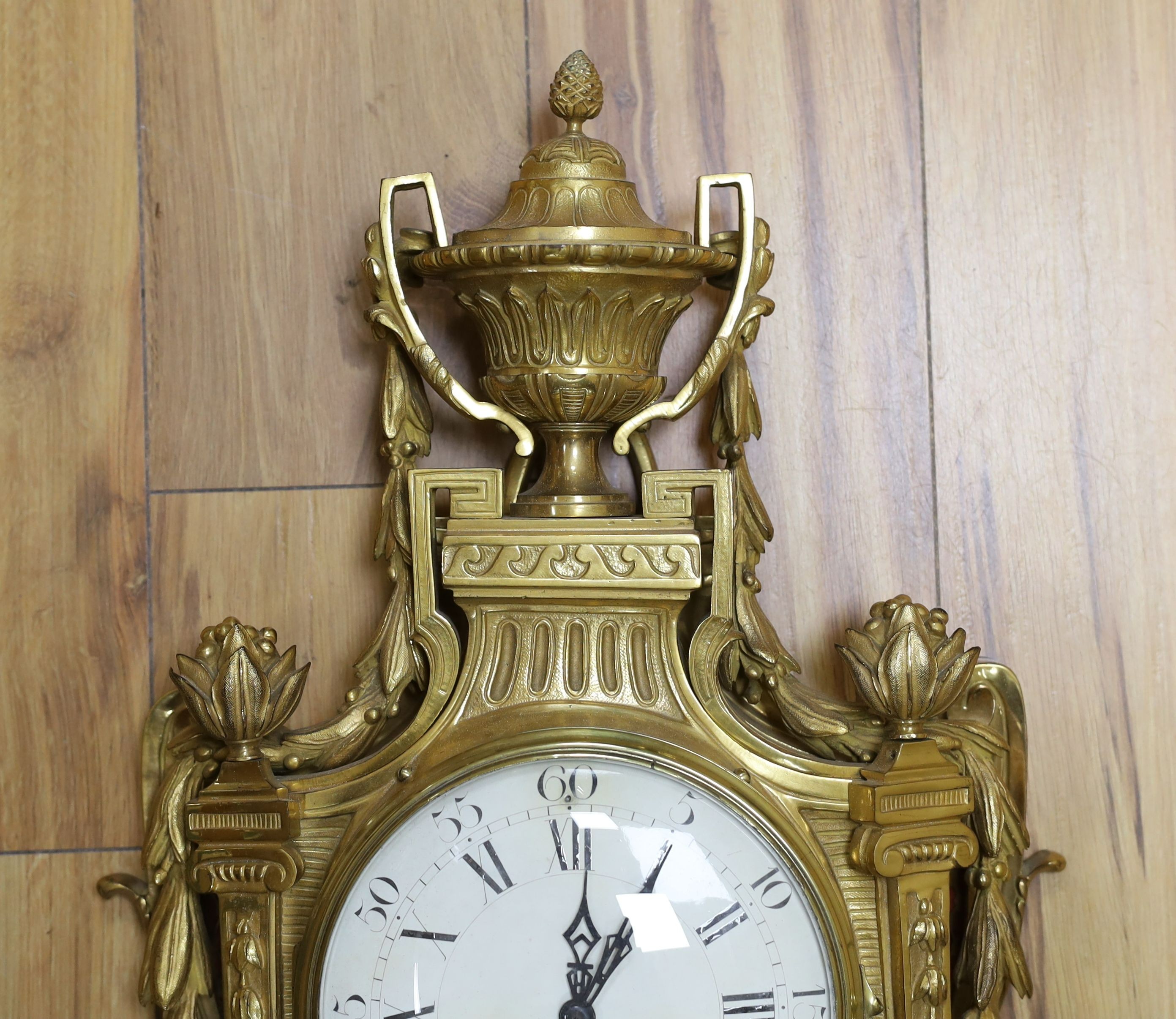 A decorative brass Cartel wall clock - 80cm tall